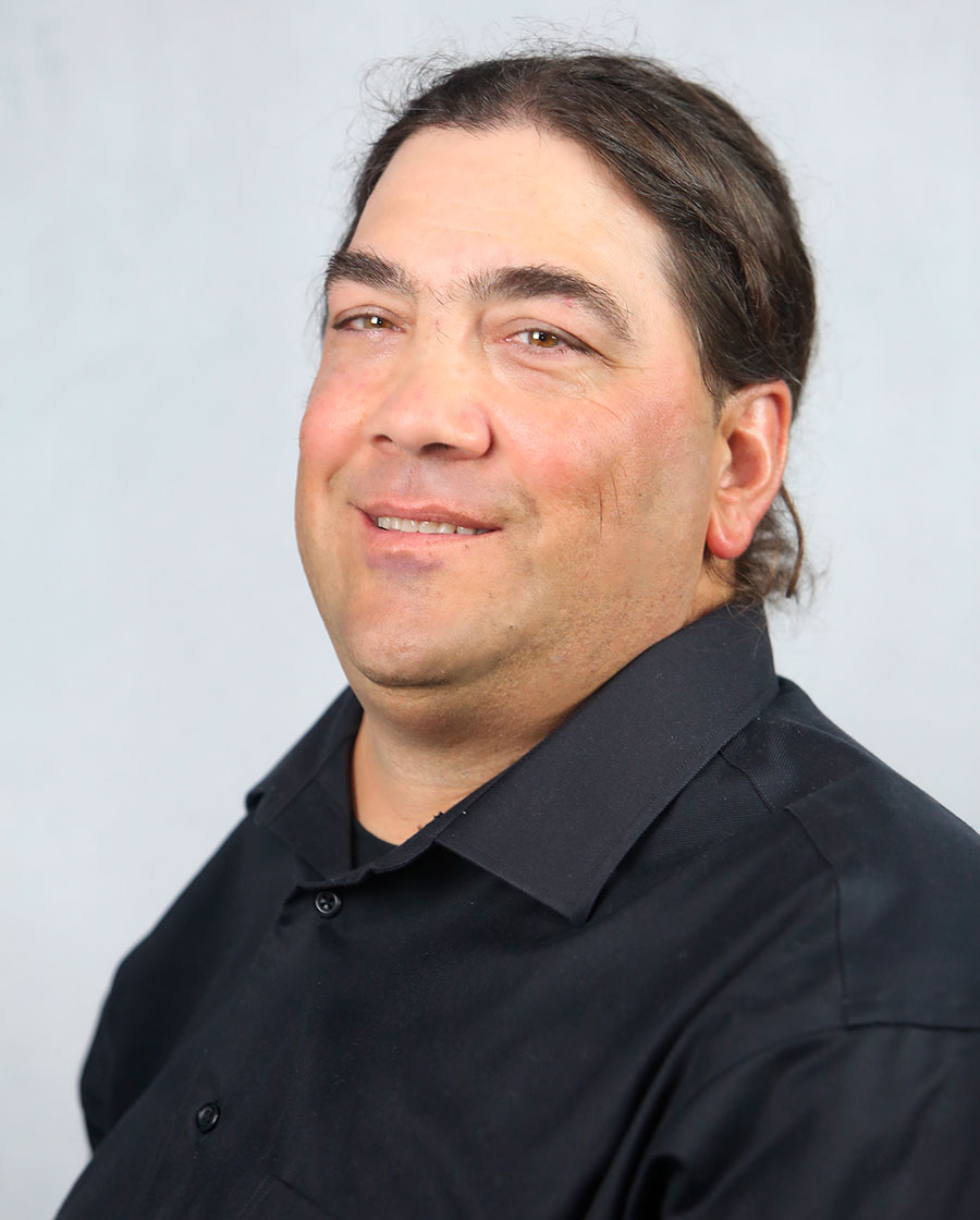 portrait of trey. he has longish brown hair and is wearing a black shirt